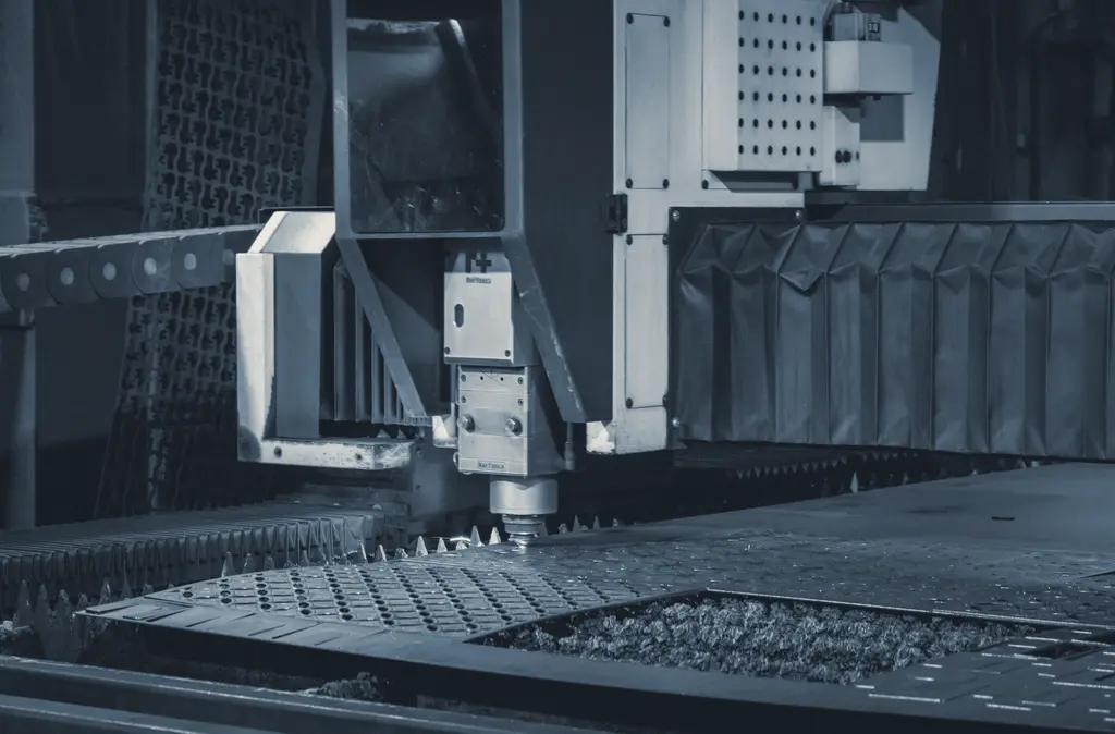 An industrial laser cutter working on a metal sheet